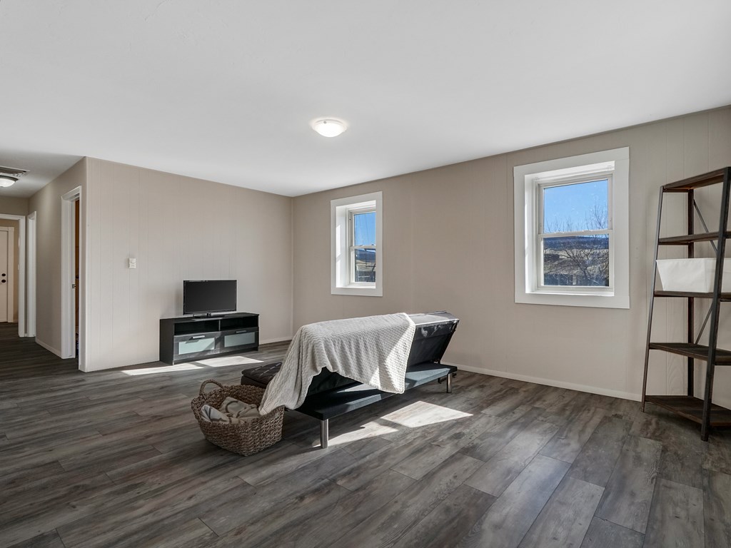 653 39 Road Palisade, CO 81526 - Photo 6 of 35 a bedroom with furniture and a wooden floor