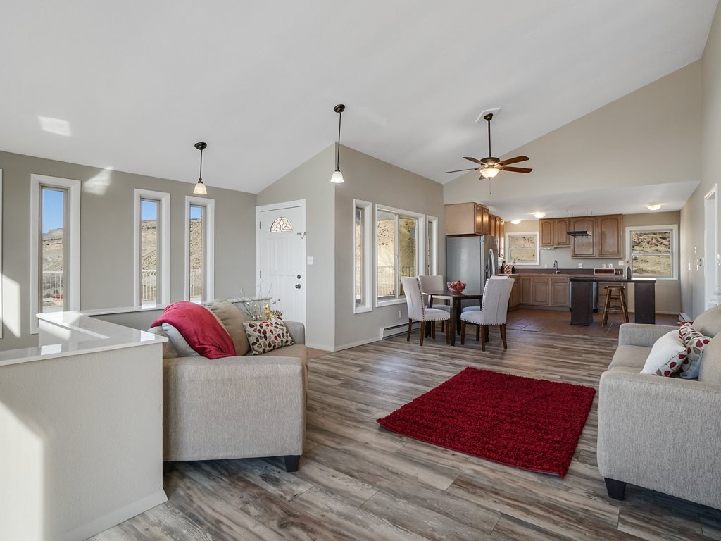653 39 Road Palisade, CO 81526 - Photo 8 of 35 a living room with furniture kitchen view and a chandelier