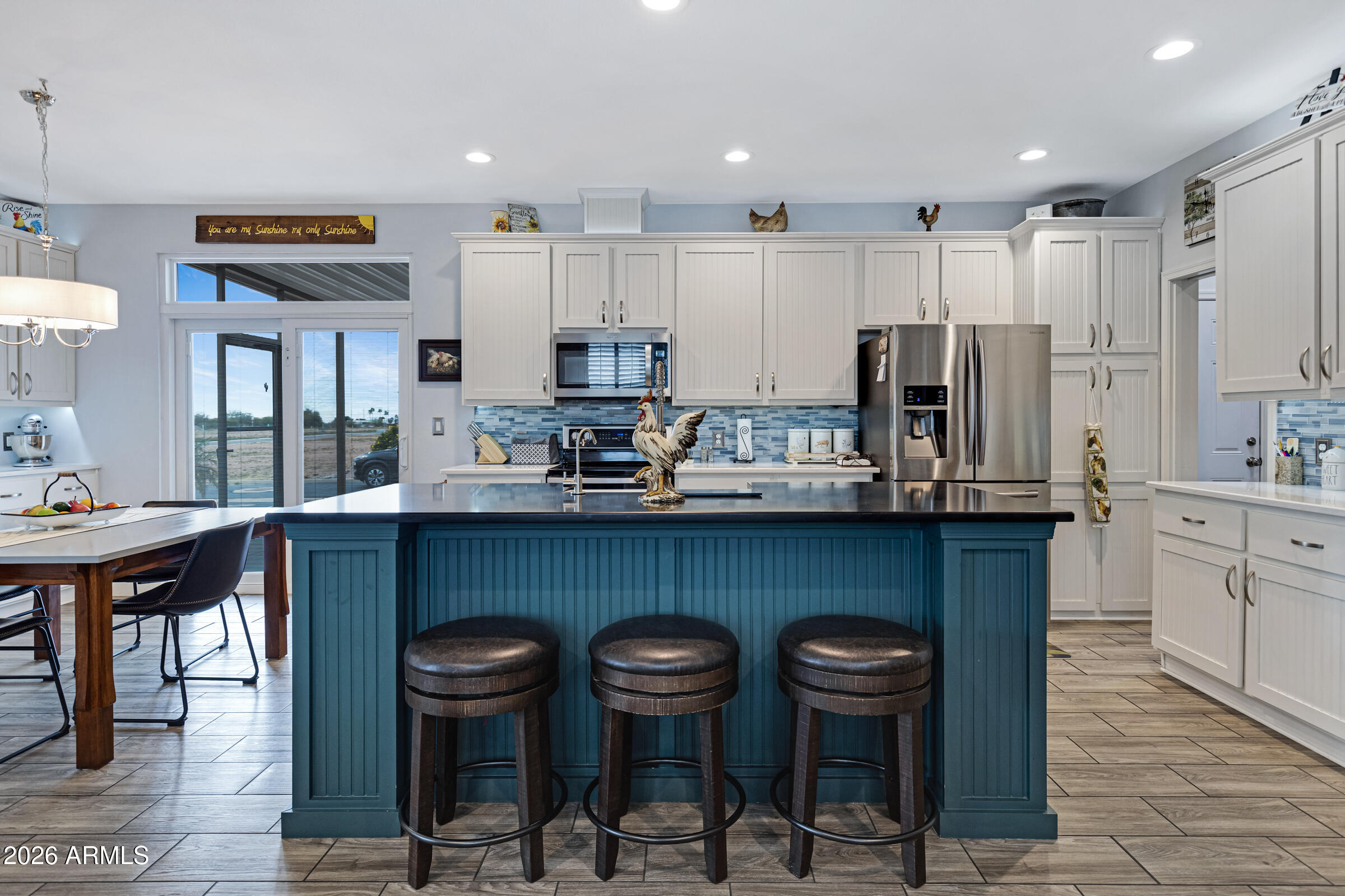 3301 South Goldfield Road, Unit 6055 Apache Junction, AZ 85119 - Photo 13 of 49 a kitchen with stainless steel appliances a table and chairs in it