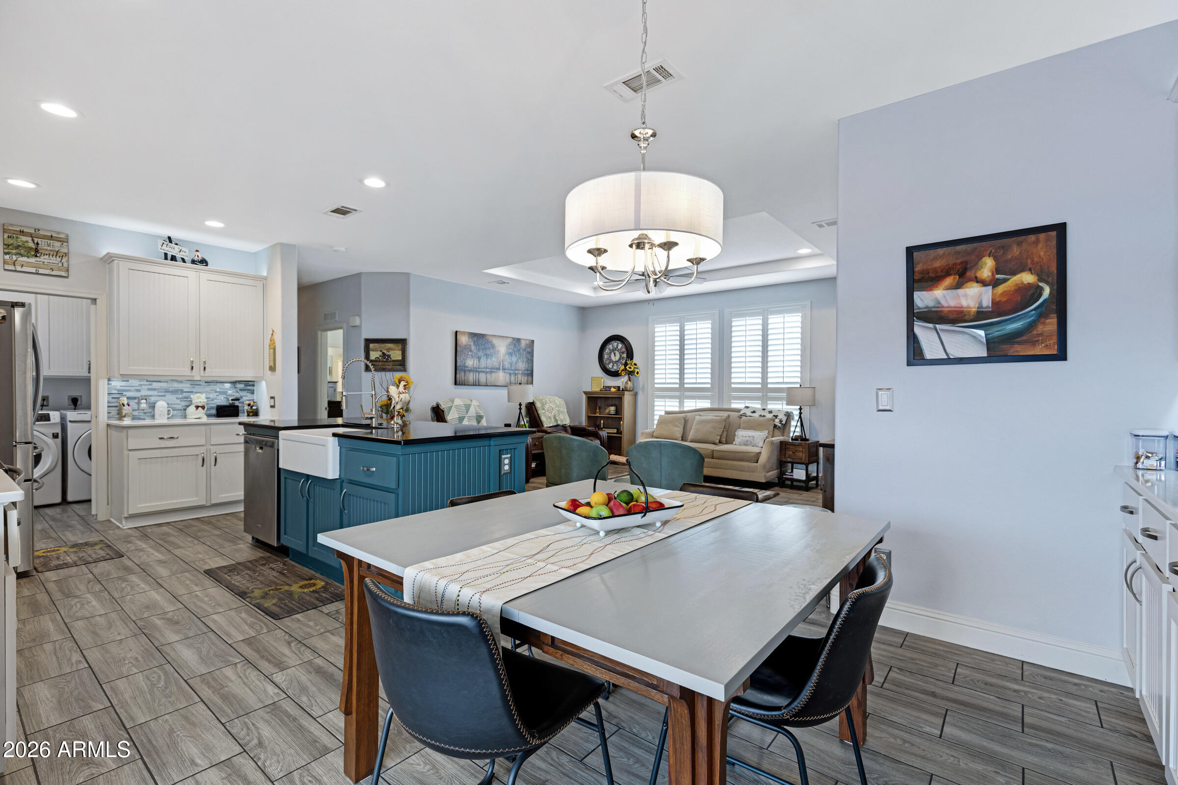 3301 South Goldfield Road, Unit 6055 Apache Junction, AZ 85119 - Photo 17 of 49 a view of a dining room with furniture a kitchen and chandelier