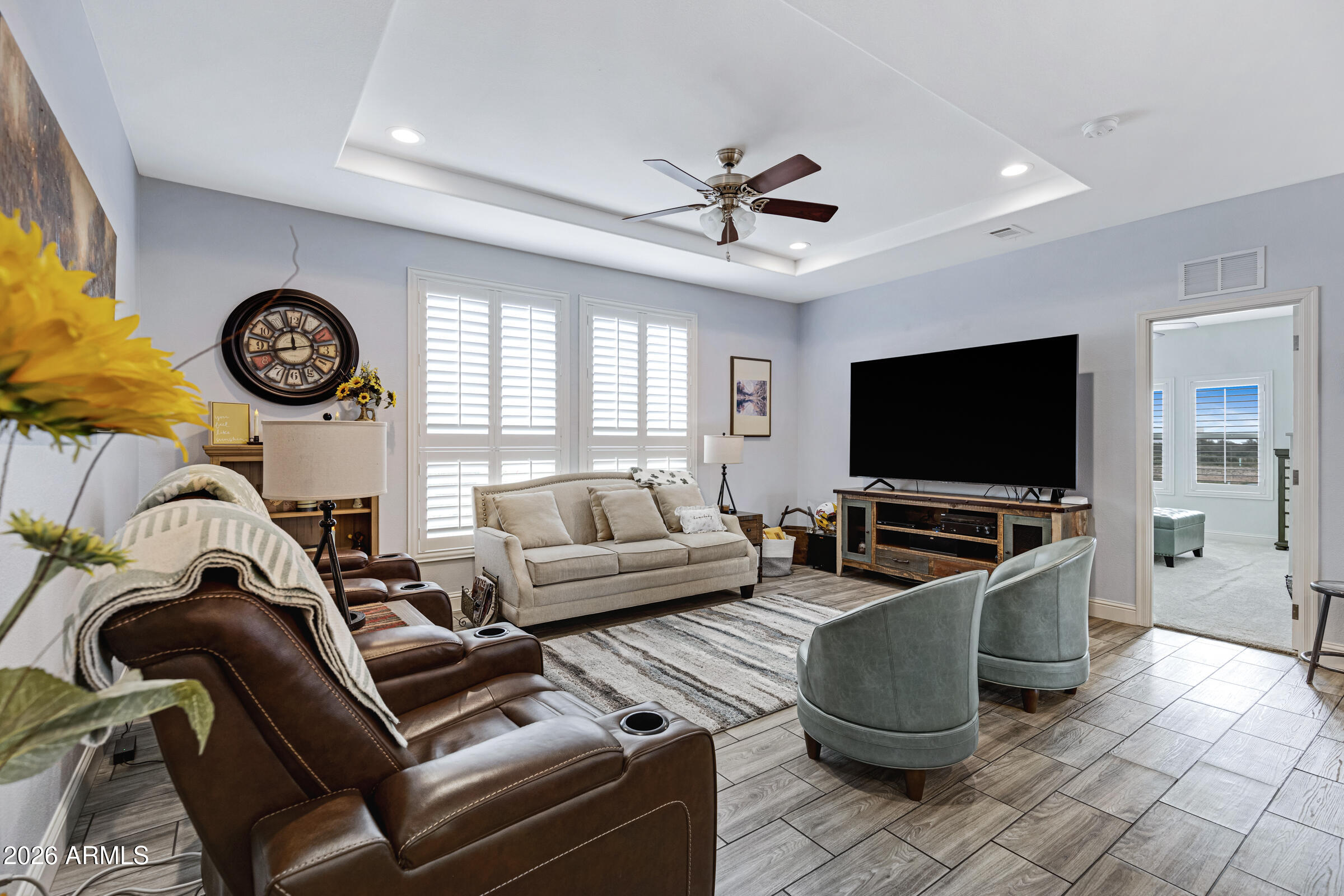 3301 South Goldfield Road, Unit 6055 Apache Junction, AZ 85119 - Photo 18 of 49 a living room with furniture a flat screen tv and a window