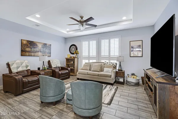 a living room with furniture a window and a flat screen tv