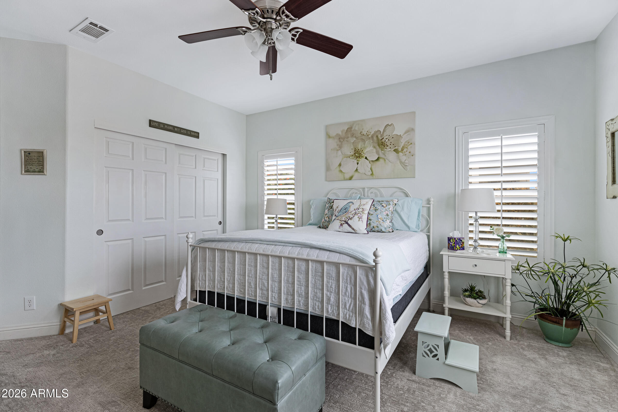 3301 South Goldfield Road, Unit 6055 Apache Junction, AZ 85119 - Photo 20 of 49 a bedroom with a bed and a chandelier