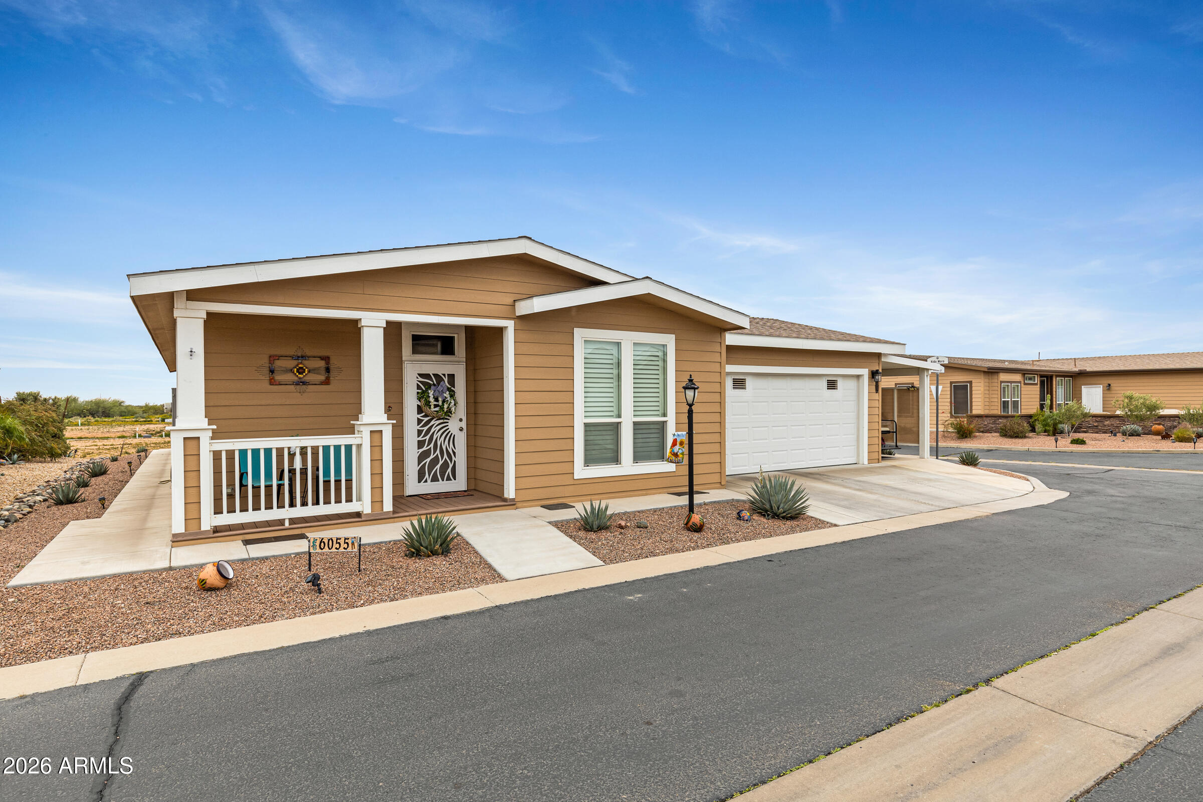 3301 South Goldfield Road, Unit 6055 Apache Junction, AZ 85119 - Photo 2 of 49 a front view of a house with a yard