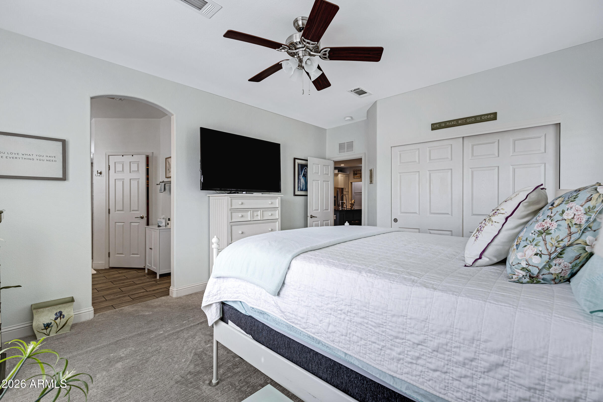 3301 South Goldfield Road, Unit 6055 Apache Junction, AZ 85119 - Photo 21 of 49 a bedroom with a bed and a flat screen tv