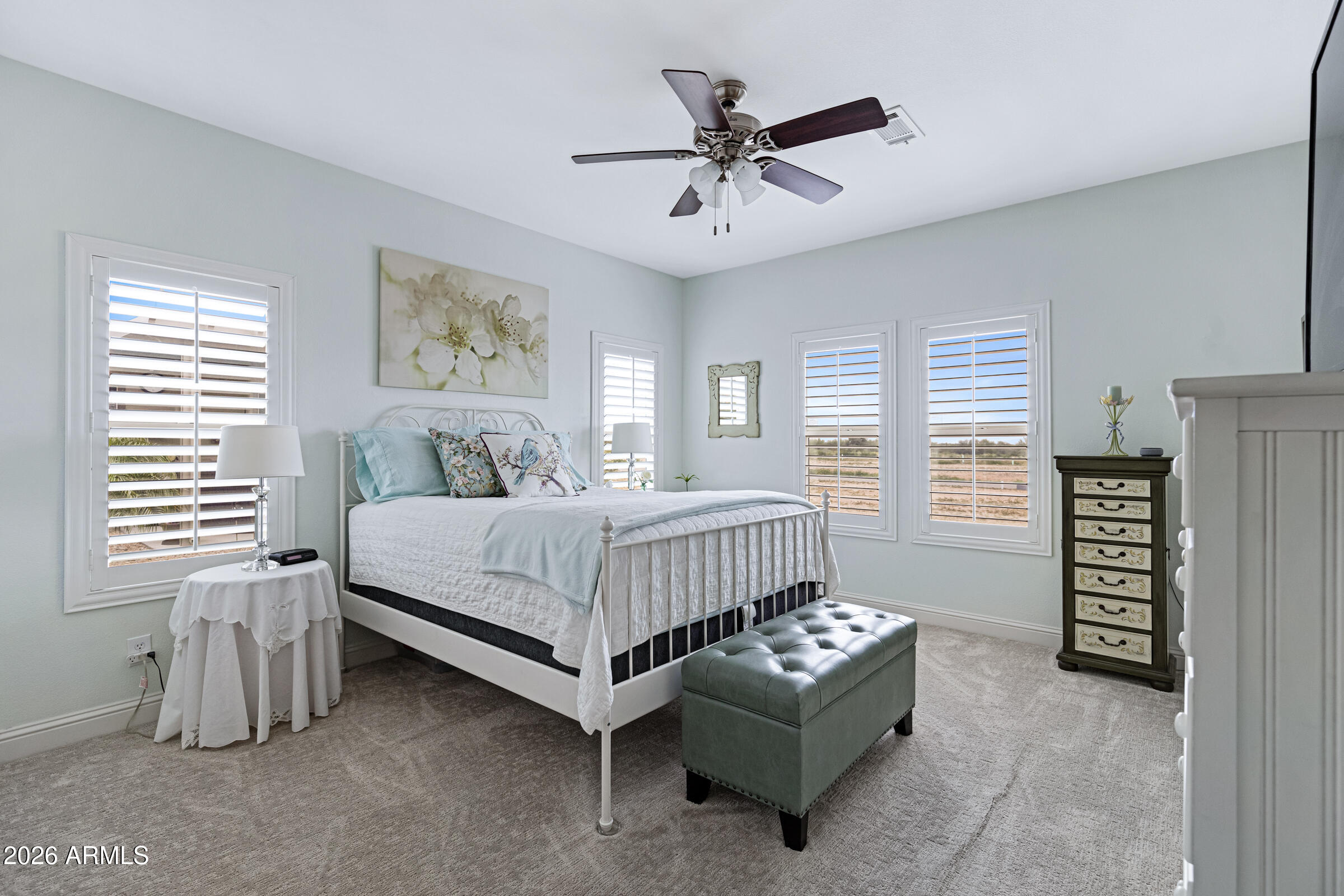 3301 South Goldfield Road, Unit 6055 Apache Junction, AZ 85119 - Photo 22 of 49 a bedroom with a bed and a chandelier