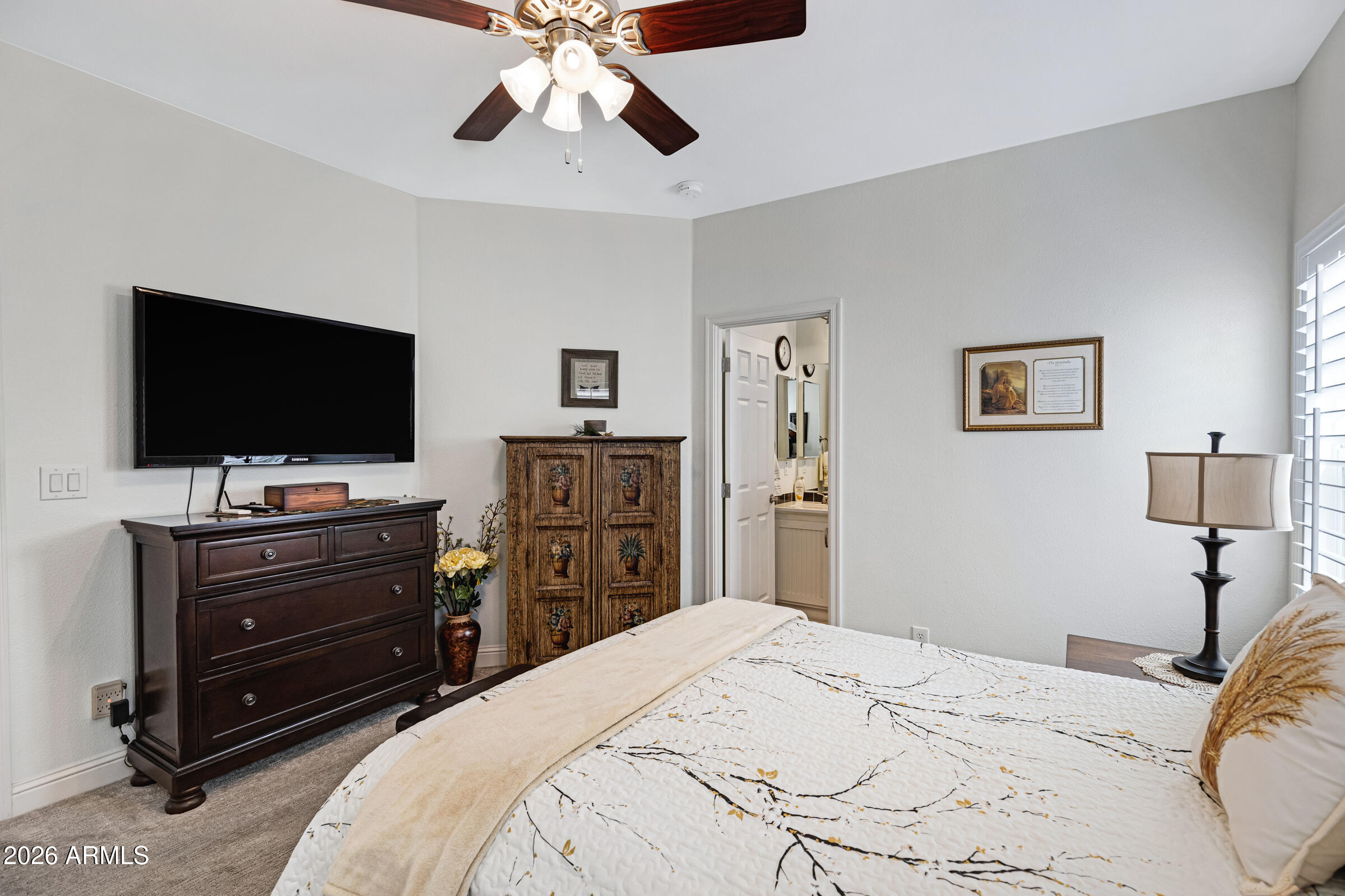 3301 South Goldfield Road, Unit 6055 Apache Junction, AZ 85119 - Photo 26 of 49 a bedroom with a bed and a flat screen tv
