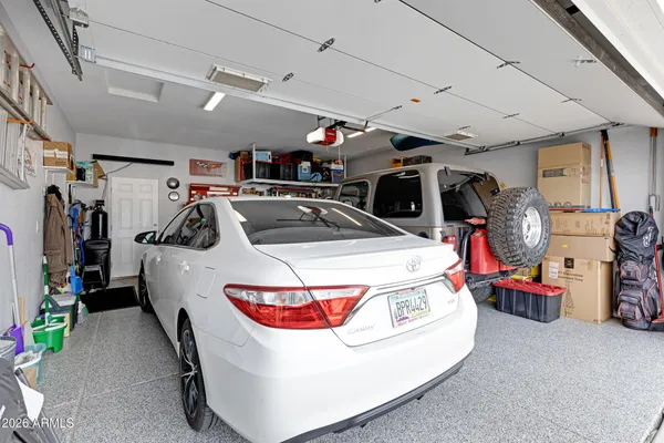 a utility room with a car and a bike