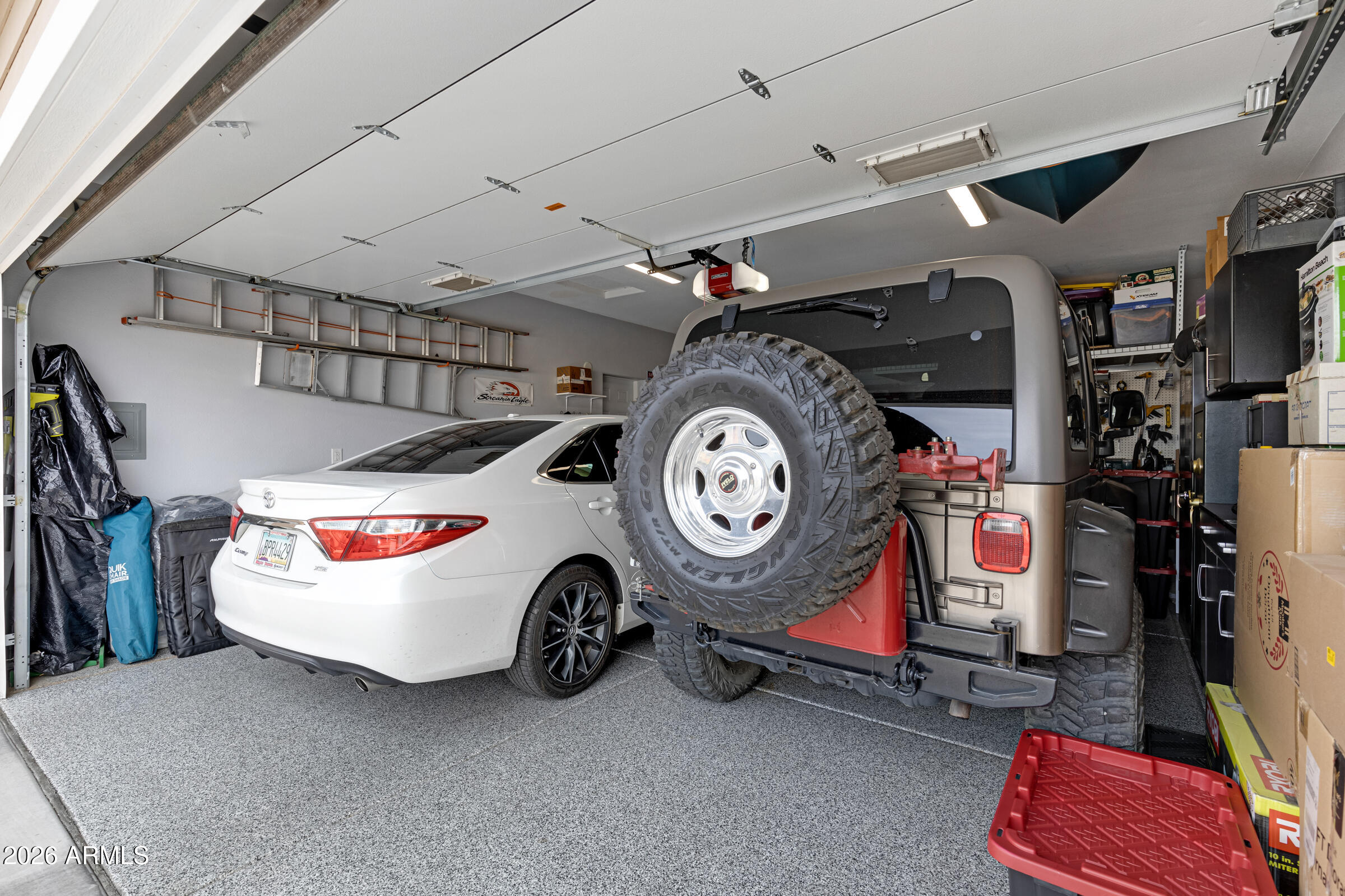 3301 South Goldfield Road, Unit 6055 Apache Junction, AZ 85119 - Photo 30 of 49 a utility room with a car and a bike