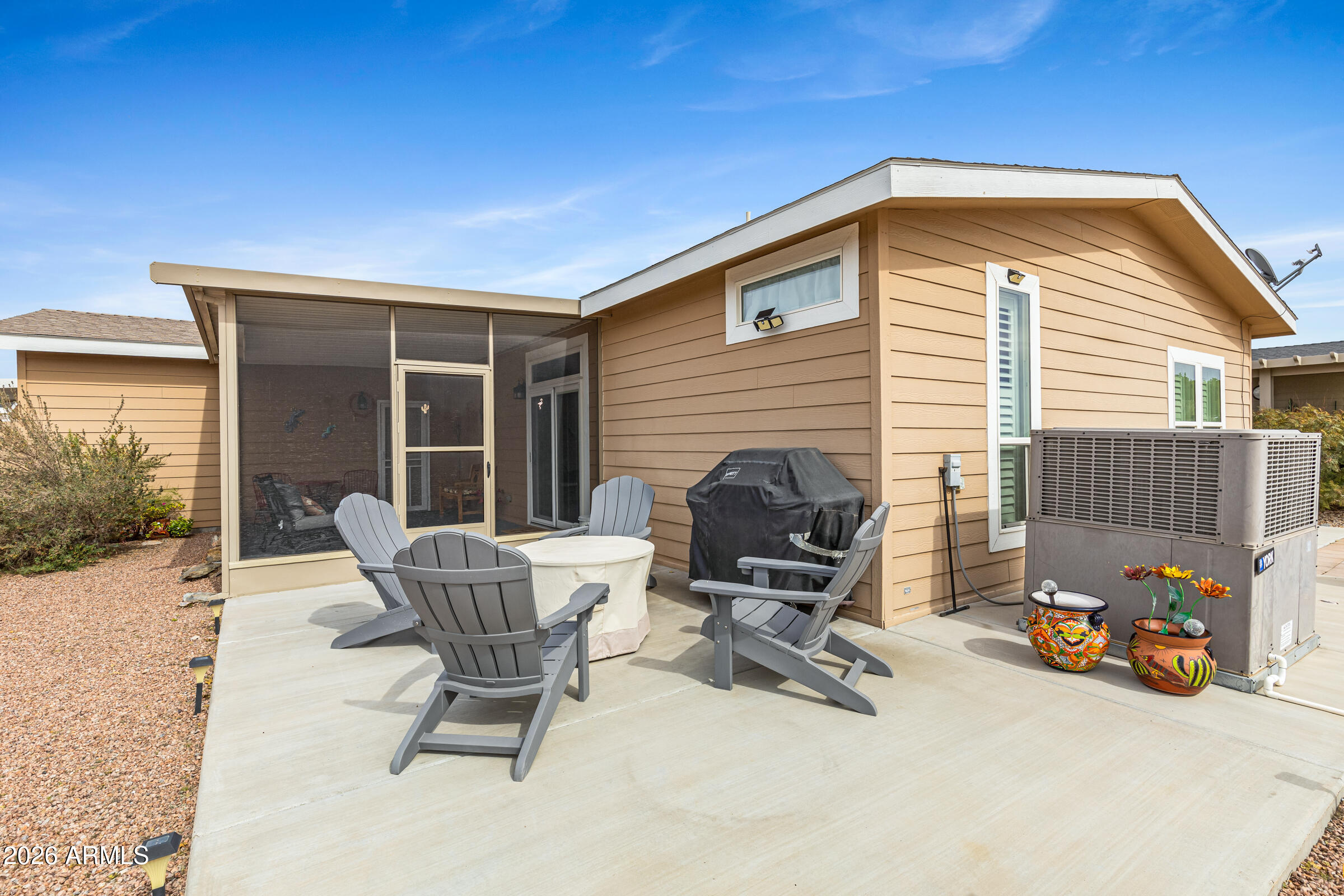 3301 South Goldfield Road, Unit 6055 Apache Junction, AZ 85119 - Photo 31 of 49 a view of backyard with a chair and dining table