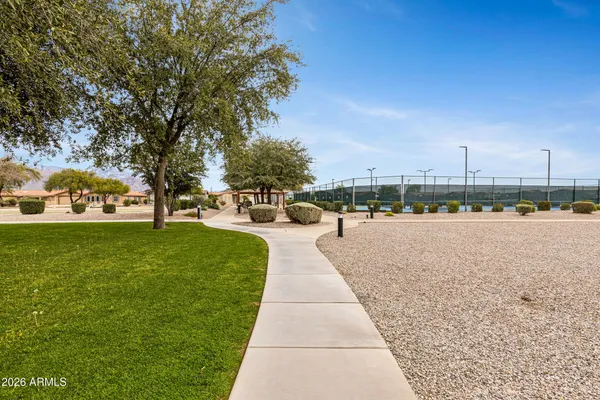 a view of a patio with table and chairs under an umbrella