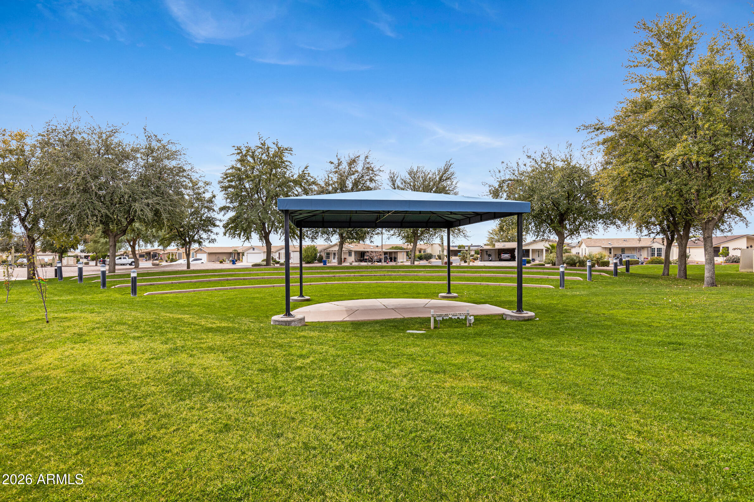 3301 South Goldfield Road, Unit 6055 Apache Junction, AZ 85119 - Photo 47 of 49 a view of a swimming pool with an outdoor space and seating area
