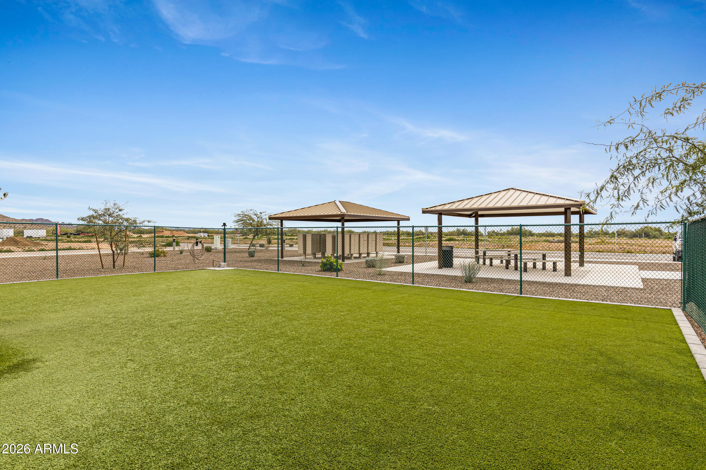 3301 South Goldfield Road, Unit 6055 Apache Junction, AZ 85119 - Photo 48 of 49 a view of a swimming pool with an outdoor seating and a garden