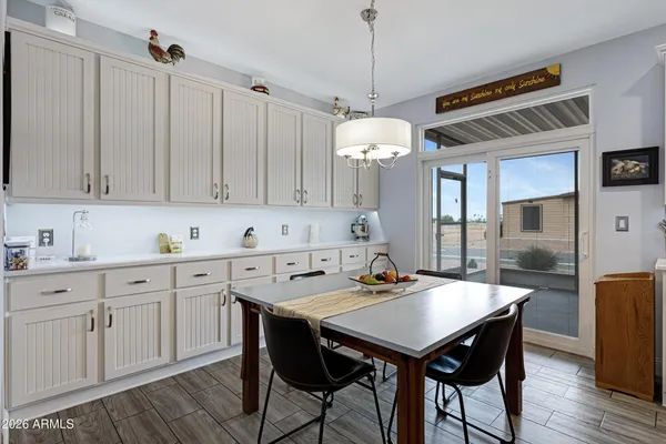 a view of a kitchen area with furniture and wooden floor