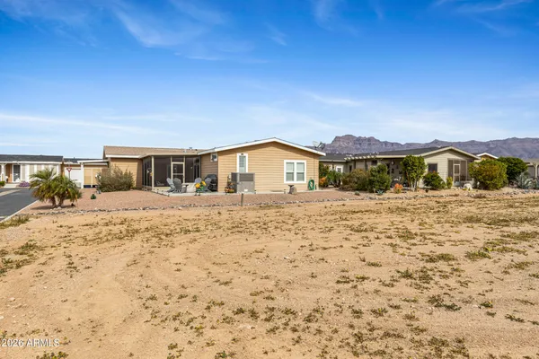a view of house with yard and ocean view