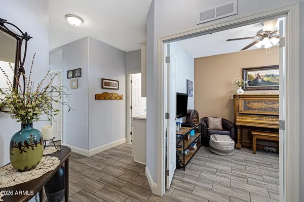 a view of a hallway to a livingroom and a dining room with furniture