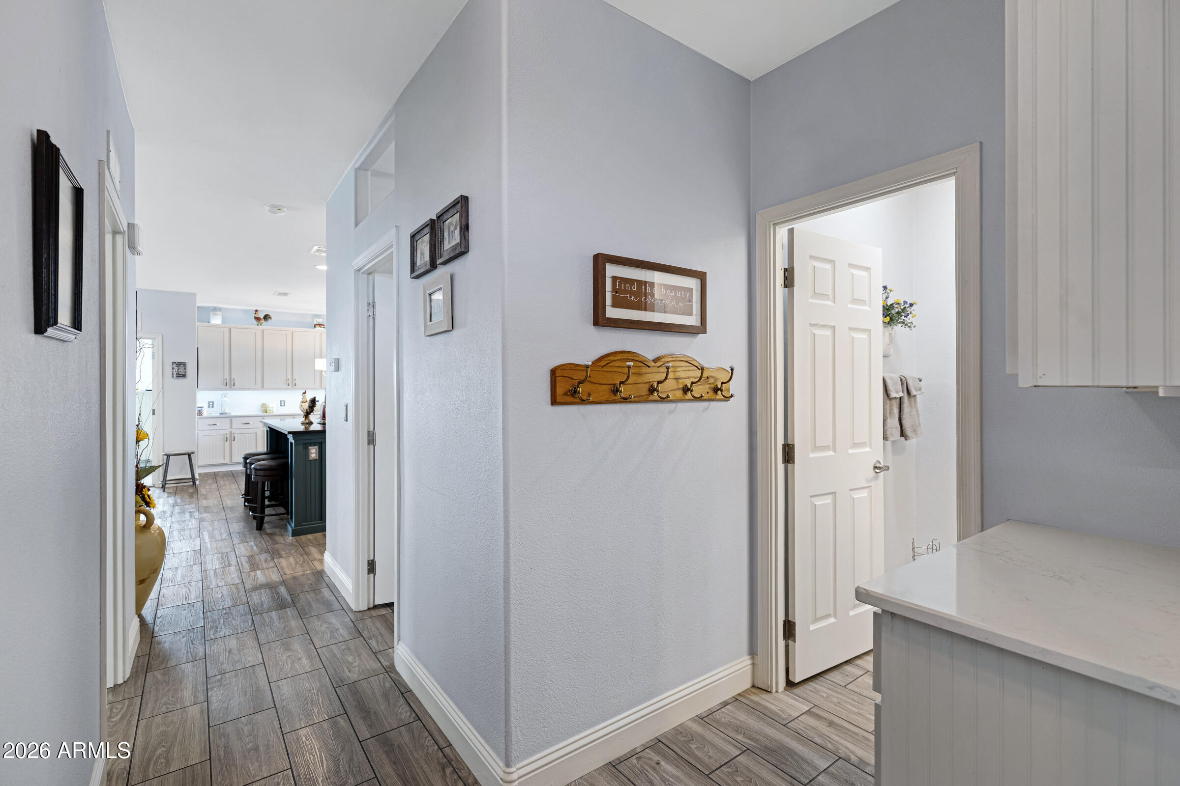 3301 South Goldfield Road, Unit 6055 Apache Junction, AZ 85119 - Photo 9 of 49 a view of a hallway with bathroom and wooden floor