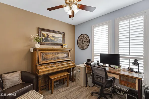 a view of a workspace with furniture and a window