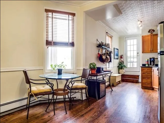 a view of a dining room with furniture and wooden floor