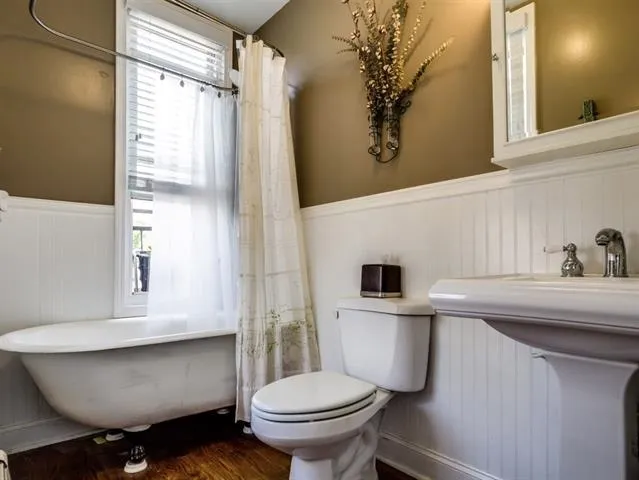 a bathroom with a sink a toilet and a mirror