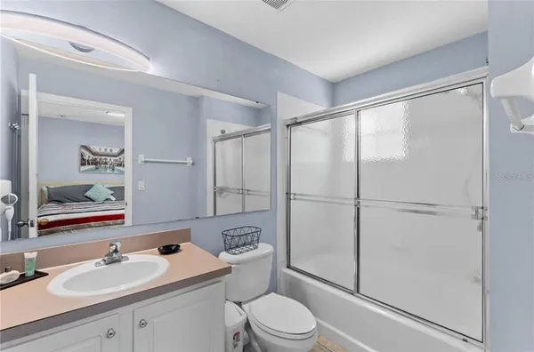 a bathroom with a sink toilet vanity and shower