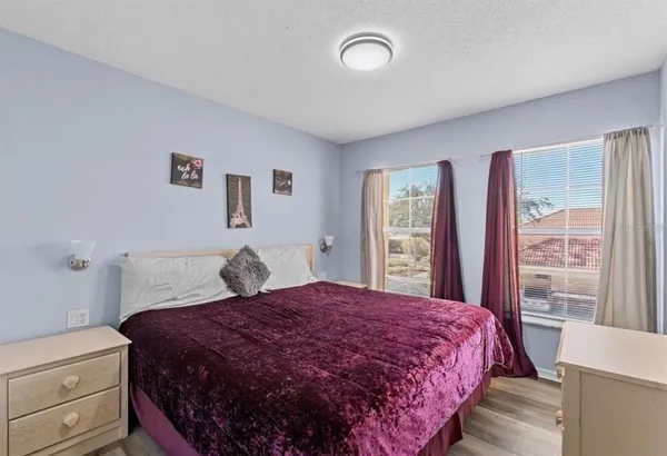 a bedroom with a large bed and a window