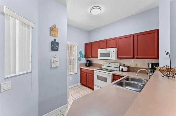 a kitchen with stainless steel appliances granite countertop a refrigerator sink and stove