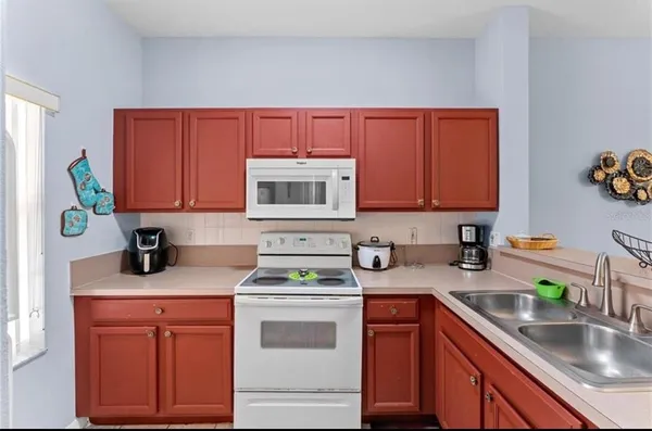 a kitchen with stainless steel appliances granite countertop a sink dishwasher stove and cabinets