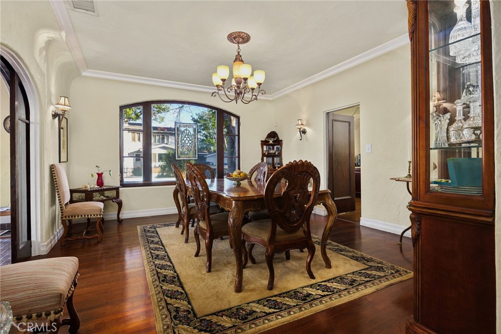 4202 University Riverside, CA 92501 - Photo 15 of 53 a view of a dining room with furniture a chandelier and wooden floor