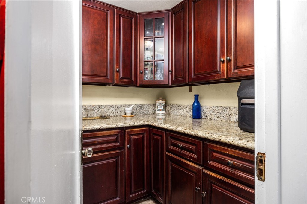 4202 University Riverside, CA 92501 - Photo 32 of 53 a kitchen with stainless steel appliances granite countertop wooden cabinets a sink and dishwasher