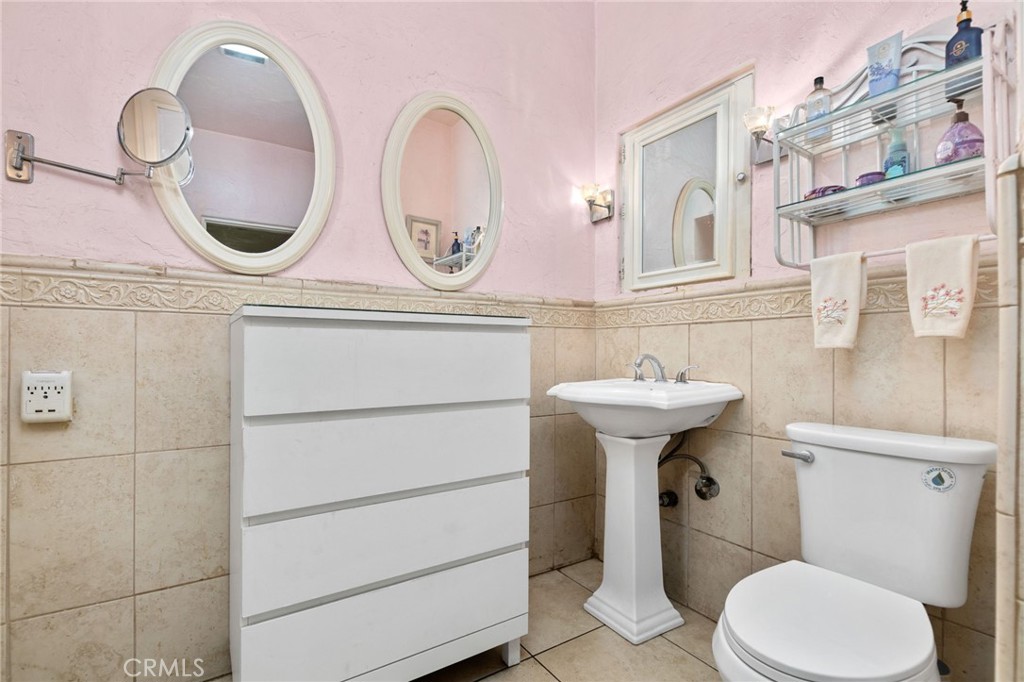 4202 University Riverside, CA 92501 - Photo 39 of 53 a bathroom with a sink mirror toilet and a window