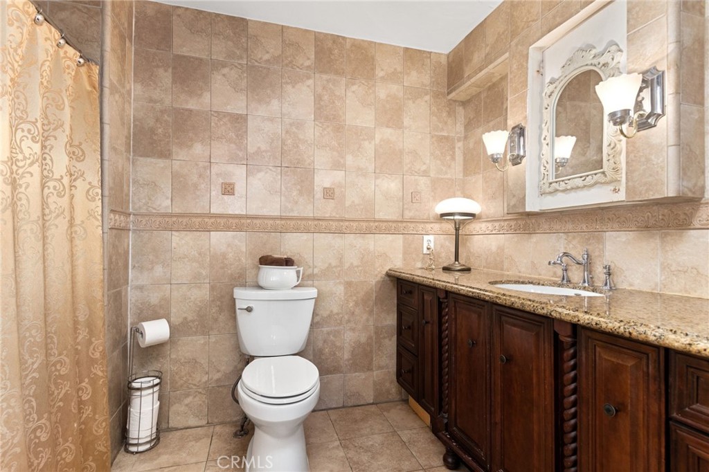 4202 University Riverside, CA 92501 - Photo 47 of 53 a bathroom with a toilet sink and mirror