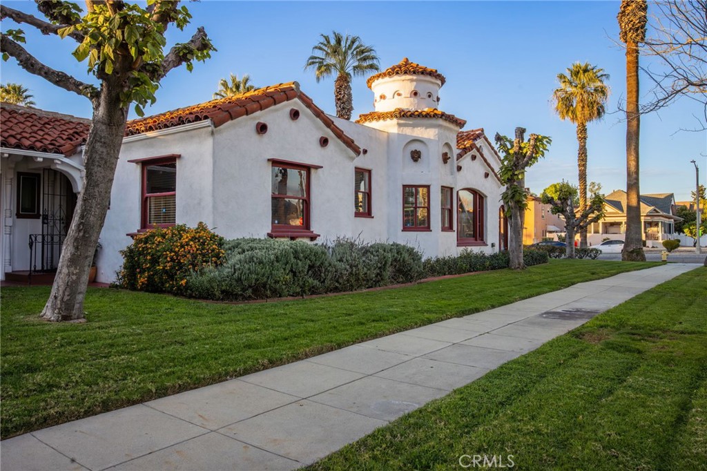 4202 University Riverside, CA 92501 - Photo 6 of 53 a view of a white house with a big yard and potted plants