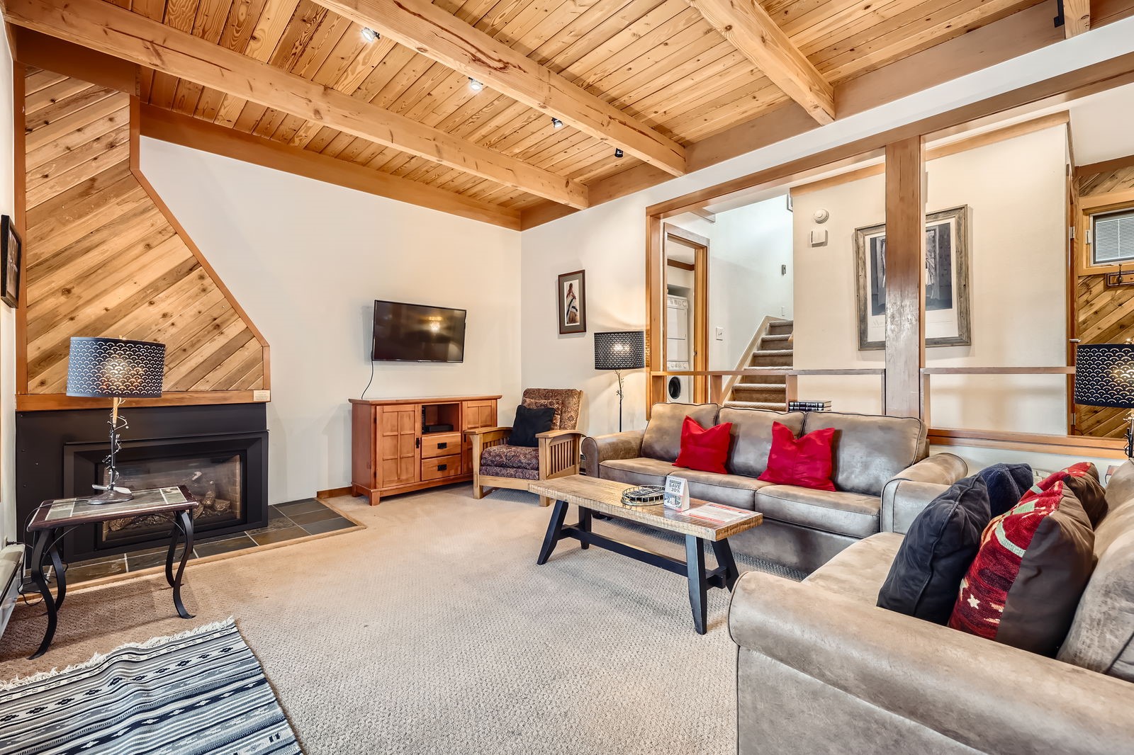 440 Tennis Club Road, Unit 1321 Keystone, CO 80435 - Photo 2 of 42 A spacious living room perfect for gatherings, featuring charming wood ceilings that add a warm, rustic mountain ambiance