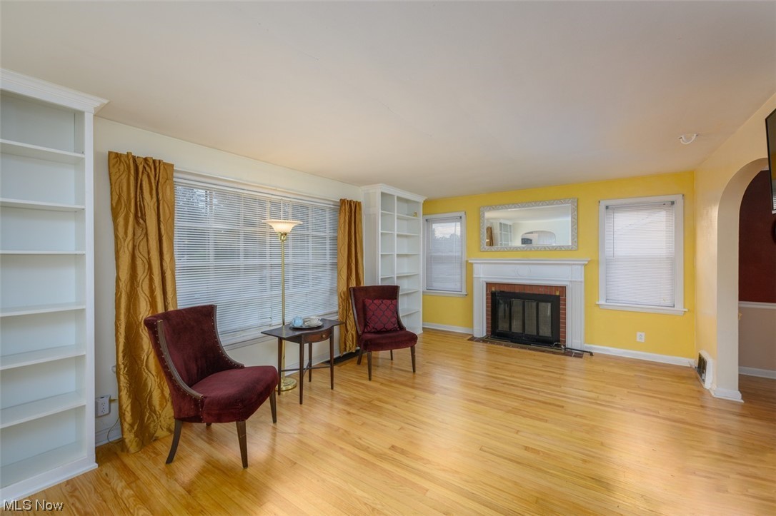 241 Everhard Road Southwest North Canton, OH 44709 - Photo 2 of 21 Living room featuring a fireplace and light wood flooring