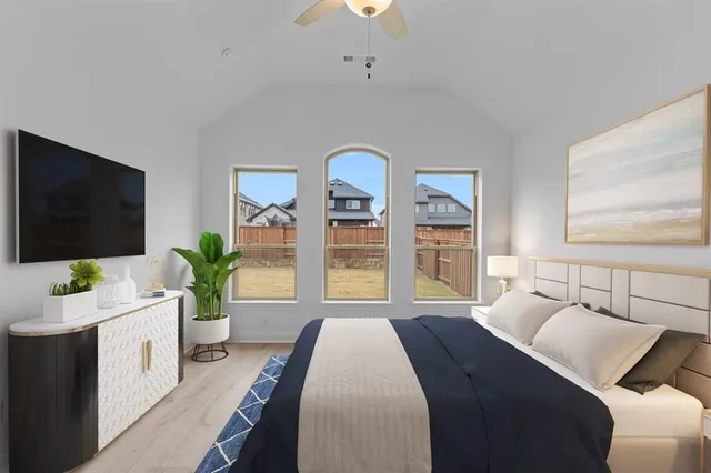 a bedroom with a bed and a flat screen tv