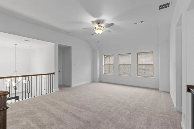 a view of a livingroom with a ceiling fan and window