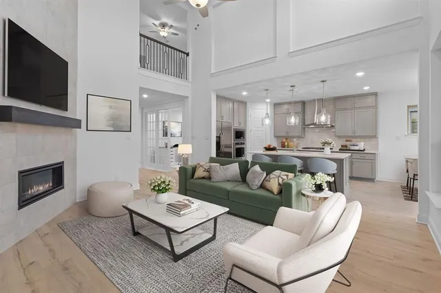 a living room with furniture a flat screen tv and a fireplace