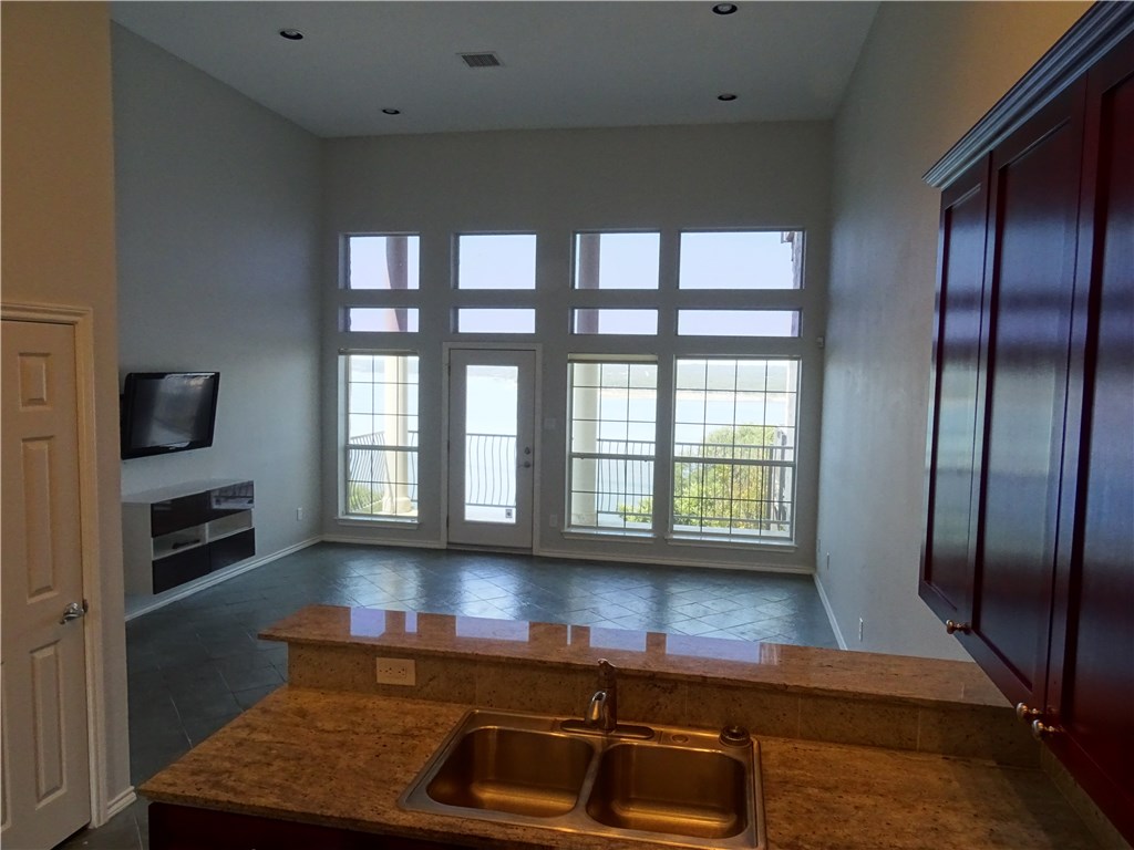 2918 Ranch Road 620, Unit K170 Austin, TX 78734 - Photo 15 of 22 A spacious living area with soaring ceilings and an abundance of natural light offers serene views.