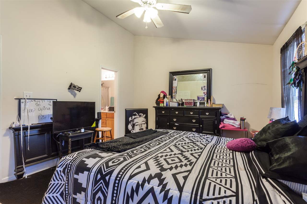 4000 Volkswalk Place Raleigh, NC 27610 - Photo 13 of 21 a bedroom with a bed and a chandelier