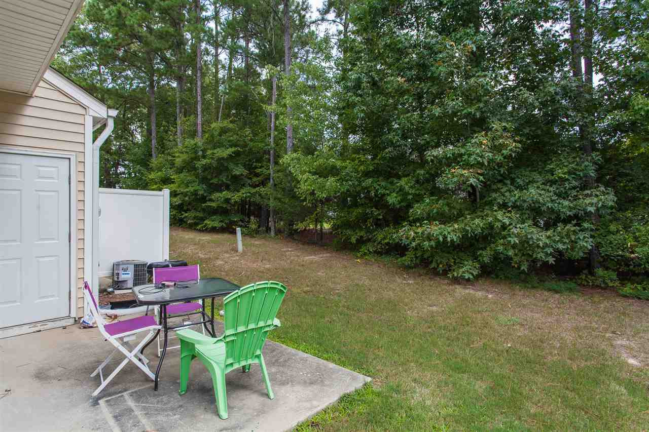 4000 Volkswalk Place Raleigh, NC 27610 - Photo 18 of 21 a chair and table sitting in backyard of house