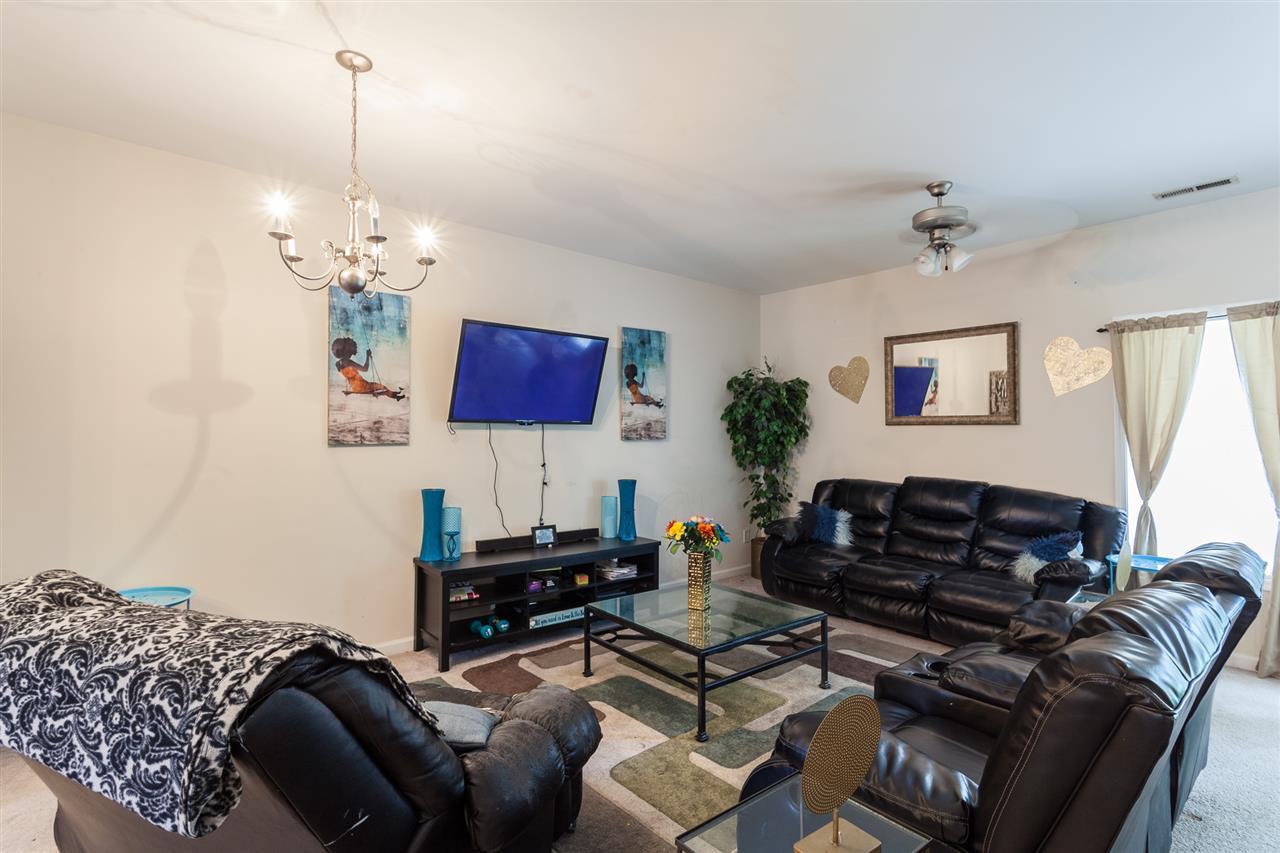 4000 Volkswalk Place Raleigh, NC 27610 - Photo 5 of 21 a living room with furniture a bed and a chandelier