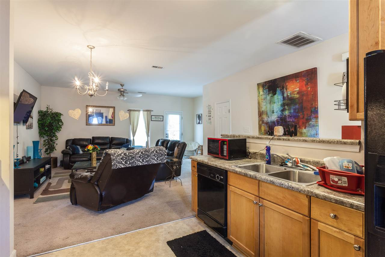 4000 Volkswalk Place Raleigh, NC 27610 - Photo 9 of 21 a living room with kitchen island furniture and a chandelier