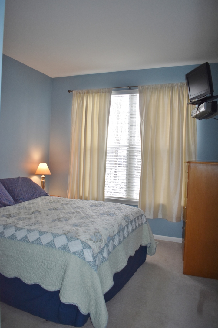 309 Ridge Road North Aurora, IL 60542 - Photo 11 of 16 a bedroom with a bed and a lamp with window