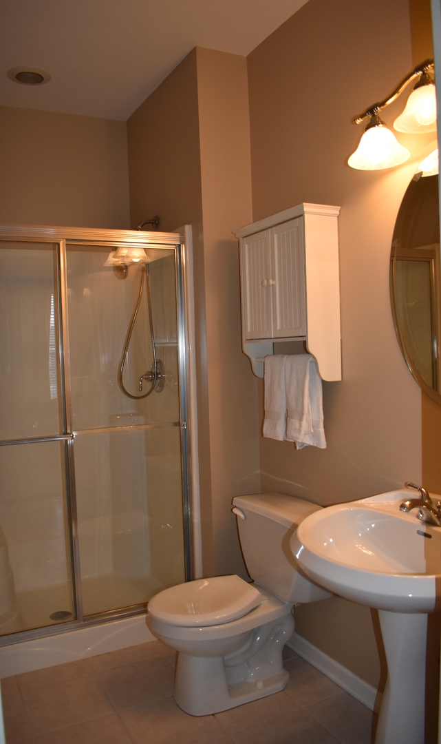 309 Ridge Road North Aurora, IL 60542 - Photo 12 of 16 a bathroom with a sink toilet and shower