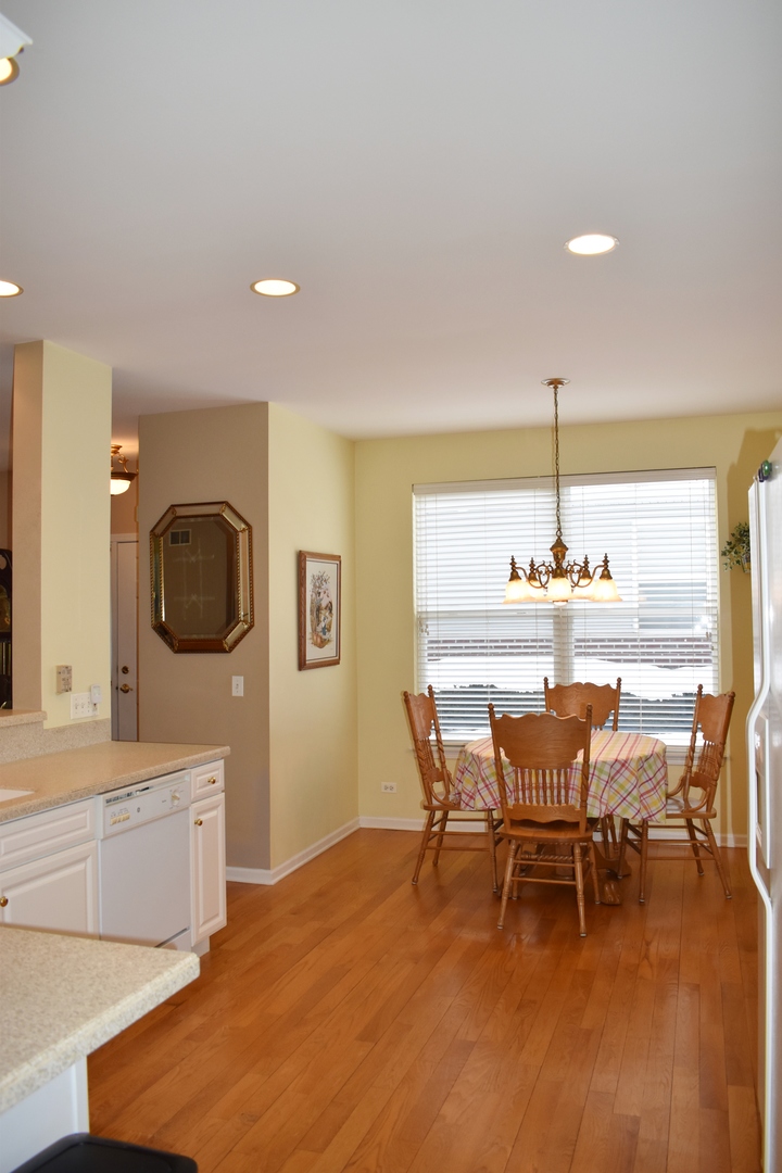 309 Ridge Road North Aurora, IL 60542 - Photo 7 of 16 a dining room with furniture and wooden floor