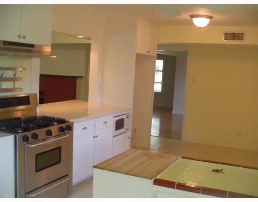 a kitchen with granite countertop a stove and a sink