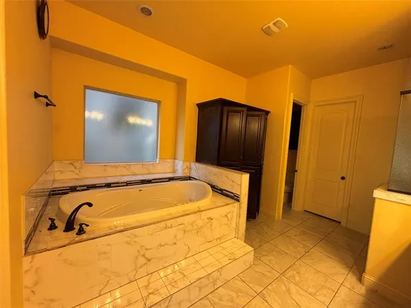 a bathroom with a tub and a shower
