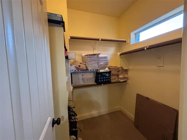 a view of storage and utility room with racks on the wall