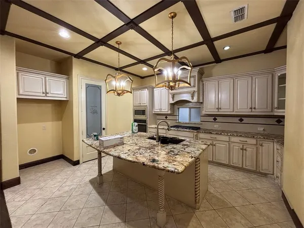 a kitchen with a stove a sink a refrigerator and cabinets